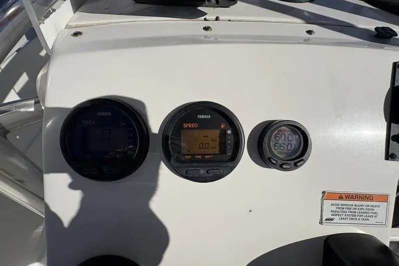 Slide: The Image of Dashboard of a 2008 Edgewater 170CC boat with Yamaha gauges and warning label. - 14