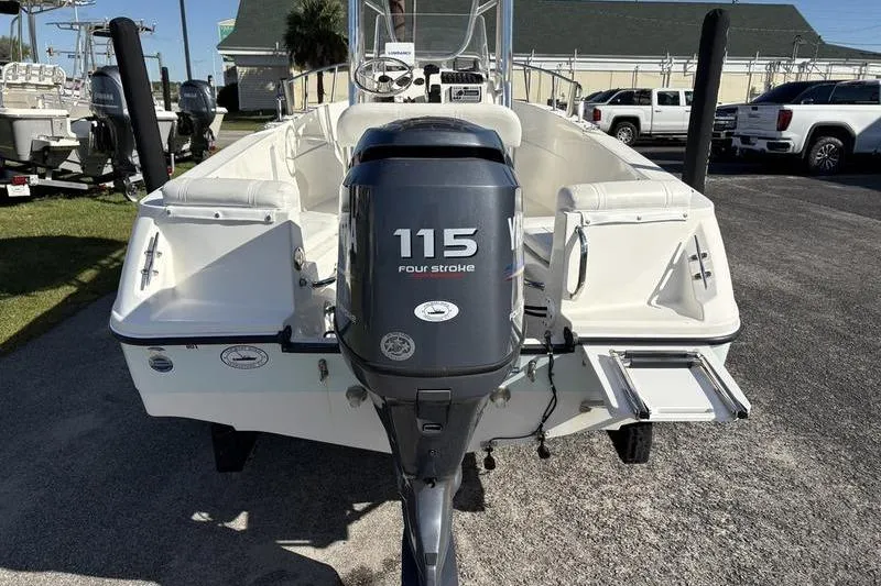 Slide: The Image of 2008 Edgewater 170CC boat with Yamaha 115 four-stroke engine, parked outdoors. - 2