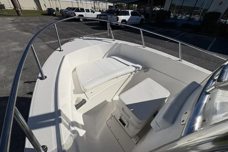 Slide: The Image of 2008 Edgewater 170CC boat interior with white seating and storage. - 21