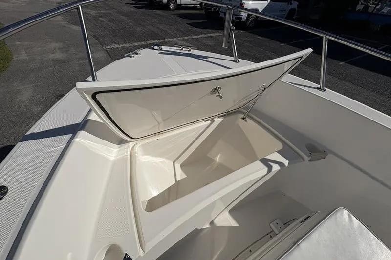 Slide: The Image of 2008 Edgewater 170CC boat with open storage compartment on deck. - 22