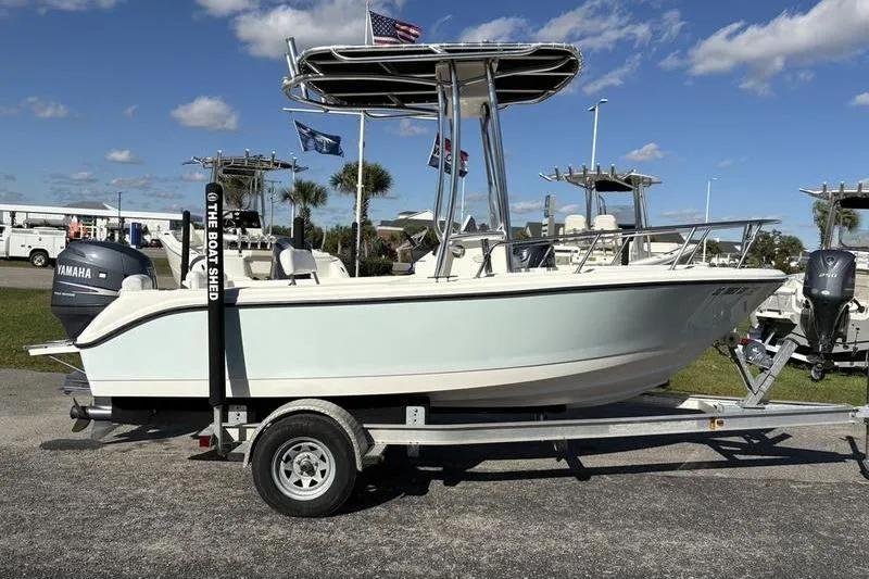 Slide: The Image of 2008 Edgewater 170CC boat on trailer, displayed outdoors under clear sky. - 4