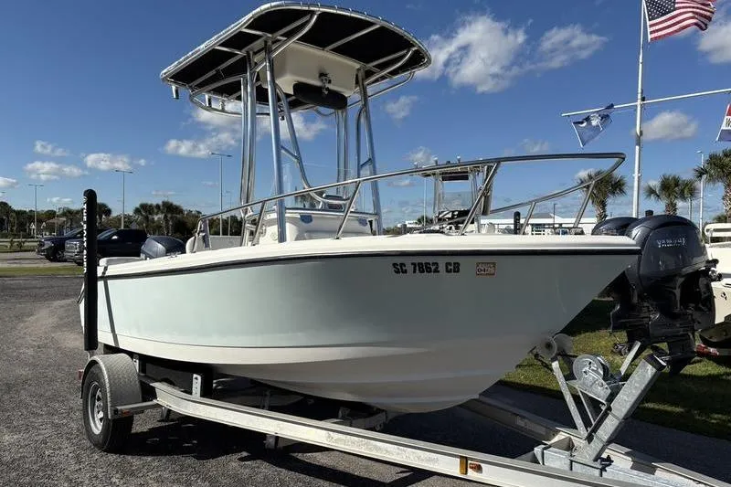 Slide: The Image of 2008 Edgewater 170CC boat on trailer, sunny day, flags in background. - 5
