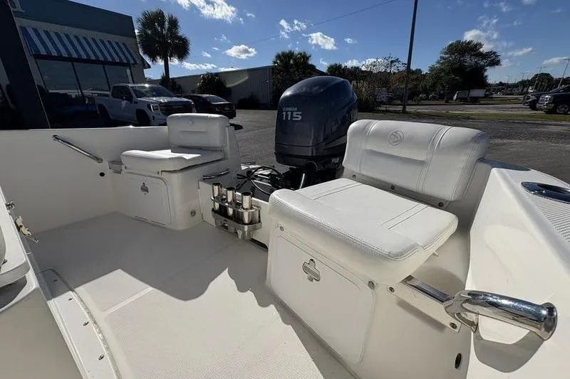 Slide: The Image of 2008 Edgewater 170CC boat interior with Yamaha 115 engine, white seating, and storage compartments. - 8