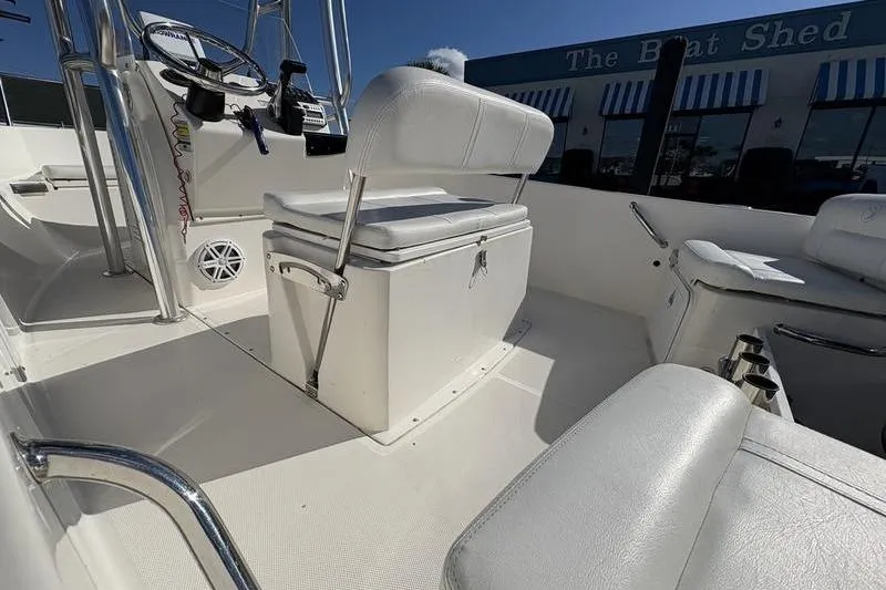 Slide: The Image of 2008 Edgewater 170CC boat interior with white seating and steering console. - 9