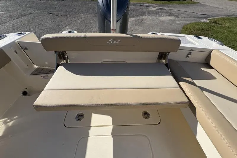 Slide: The Image of 2026 Scout 222 Dorado boat interior with beige seating and storage compartments. - 10