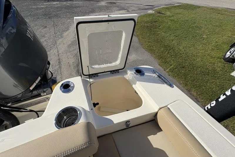 Slide: The Image of 2026 Scout 222 Dorado boat interior with open storage compartment and cup holders. - 12