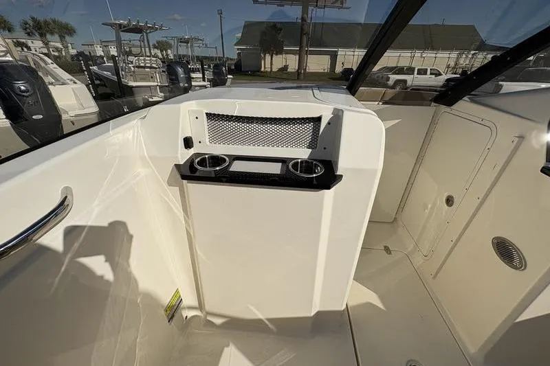 Slide: The Image of 2026 Scout 222 Dorado boat interior with cup holders and storage compartment. - 15