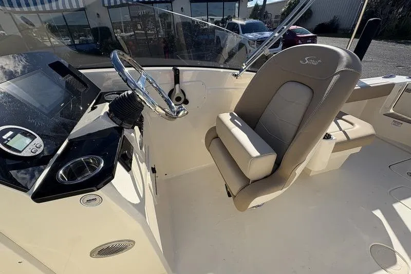 Slide: The Image of 2026 Scout 222 Dorado boat interior with steering wheel and seating. - 16