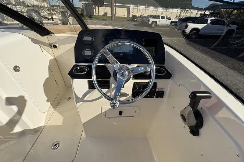 Slide: The Image of 2026 Scout 222 Dorado boat cockpit with steering wheel and control panel. - 17