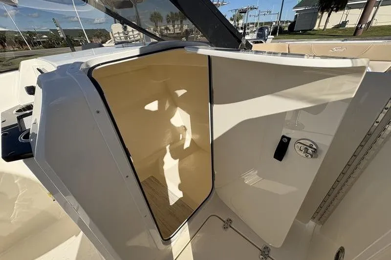 Slide: The Image of 2026 Scout 222 Dorado boat interior, featuring an open storage compartment and sleek design. - 20