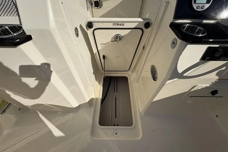 Slide: The Image of 2026 Scout 222 Dorado boat storage compartment with open hatch and visible interior. - 22