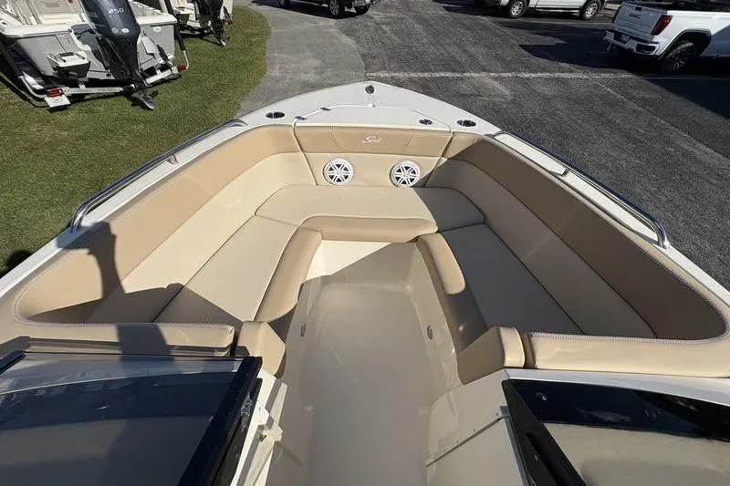 Slide: The Image of 2026 Scout 222 Dorado boat interior with beige seating and speakers. - 23