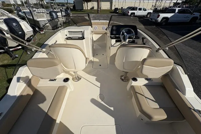Slide: The Image of 2026 Scout 222 Dorado boat interior with beige seating and modern dashboard. - 27