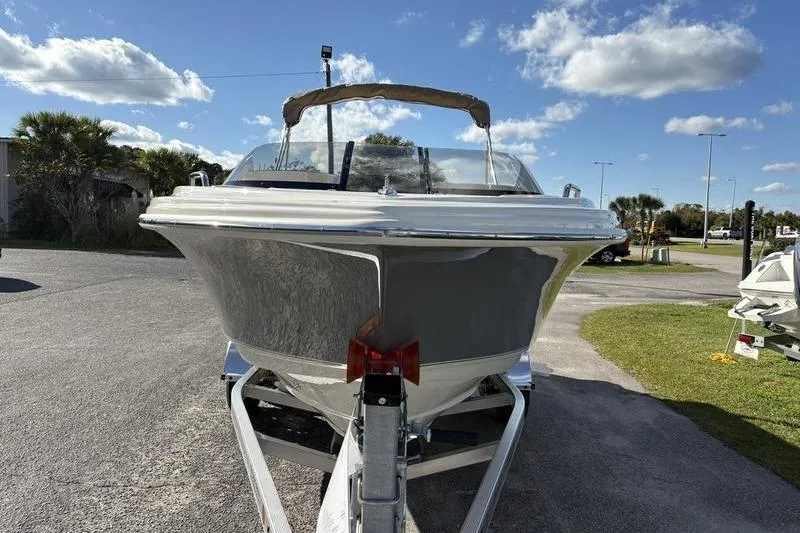 Slide: The Image of 2026 Scout 222 Dorado boat on trailer under a clear blue sky. - 6