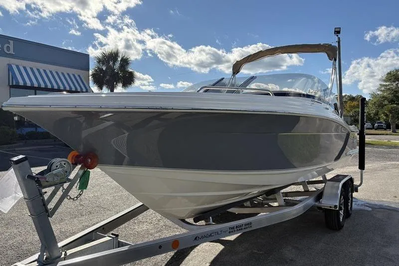 Slide: The Image of 2026 Scout 222 Dorado boat on trailer under a sunny sky. - 7