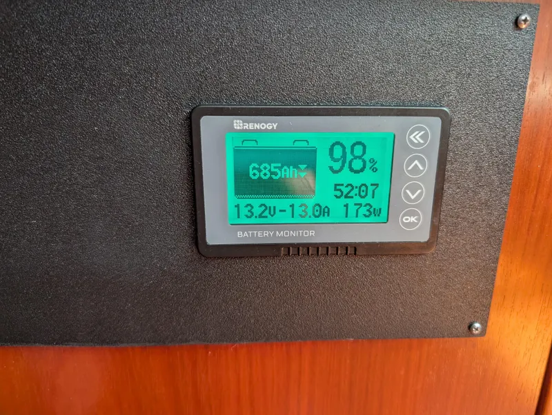 Slide: The Image of Battery monitor display on 2003 Beneteau Oceanis 473, showing 98% charge and 173W usage. - 24