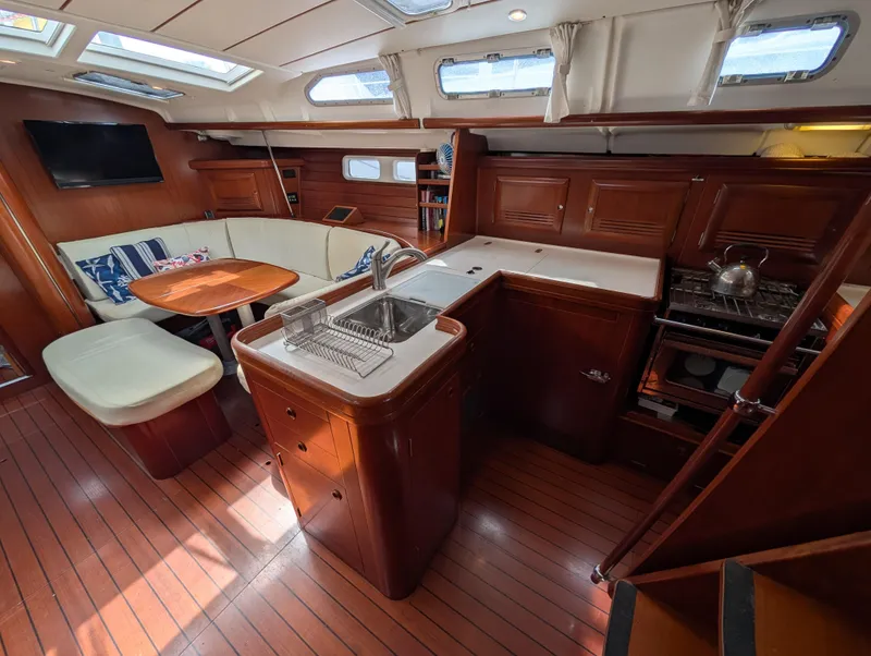 Slide: The Image of Interior of 2003 Beneteau Oceanis 473 yacht with kitchen and seating area. - 5