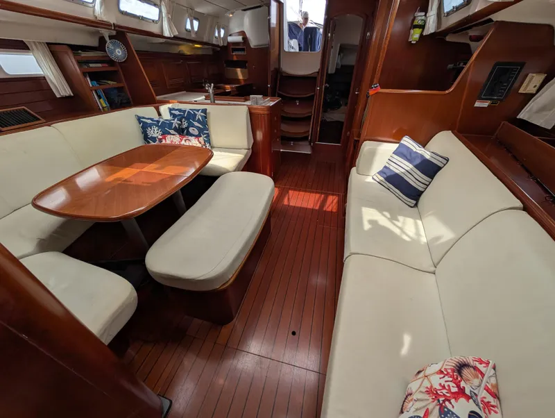 Slide: The Image of Interior of 2003 Beneteau Oceanis 473 sailboat with elegant wood finish and comfortable seating. - 7