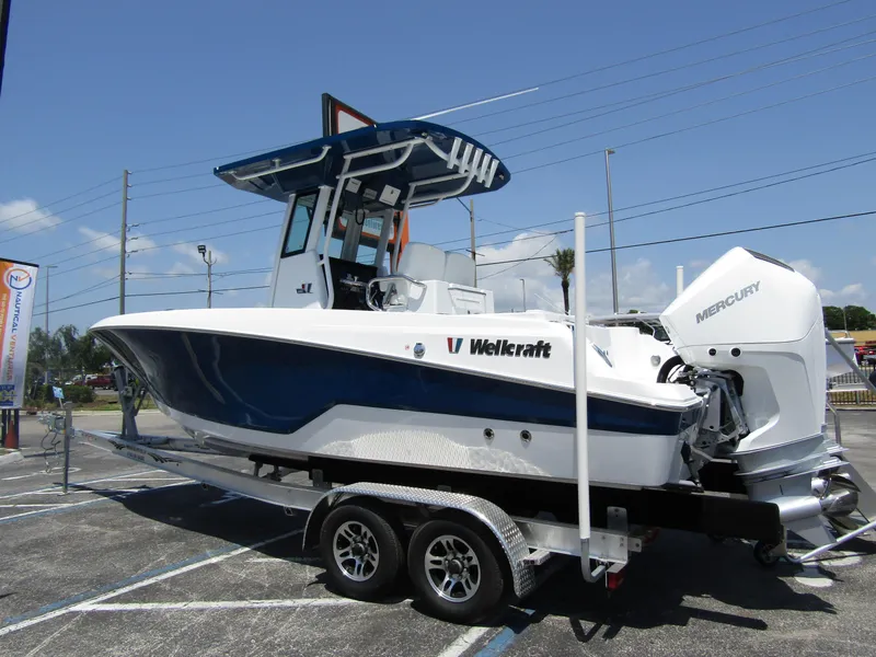 Slide: The Image of 2024 Wellcraft 243 Fisherman boat on a trailer, side view. - 1