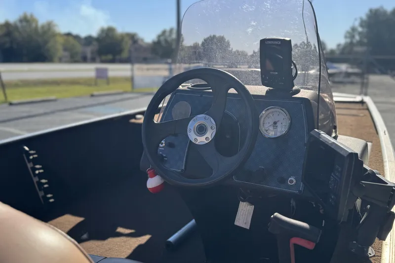 Slide: The Image of 2018 Tracker Bass Tracker 40th Anniversary Heritage Edition boat dashboard with steering wheel and gauges. - 9