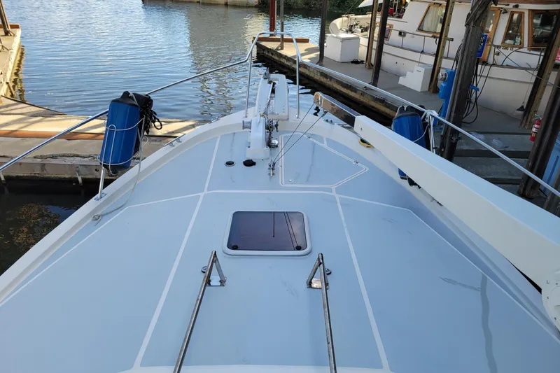 Slide: The Image of 1989 Bayliner 3888 Motoryacht docked, showcasing spacious deck and marina surroundings. - 11