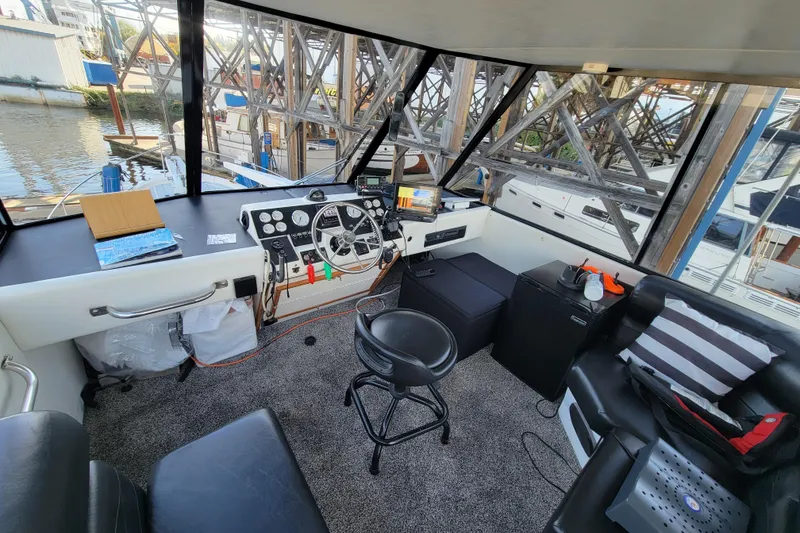 Slide: The Image of Interior of 1989 Bayliner 3888 Motoryacht cockpit with steering wheel and navigation equipment. - 13