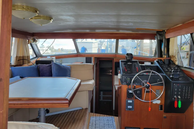 Slide: The Image of Interior of 1989 Bayliner 3888 Motoryacht with helm, seating, and wooden accents. - 23