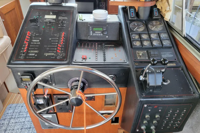 Slide: The Image of Control panel of a 1989 Bayliner 3888 Motoryacht with steering wheel and gauges. - 26