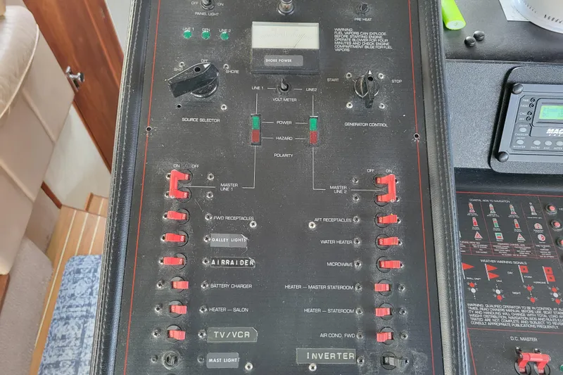 Slide: The Image of Electrical control panel on a 1989 Bayliner 3888 Motoryacht, featuring switches and meters. - 27