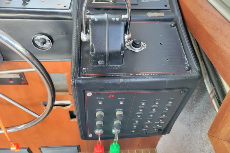 Slide: The Image of Control panel of a 1989 Bayliner 3888 Motoryacht with steering wheel and switches. - 31