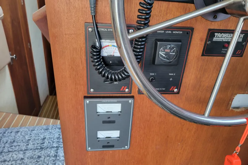 Slide: The Image of Control panel of 1989 Bayliner 3888 Motoryacht with gauges and steering wheel. - 32