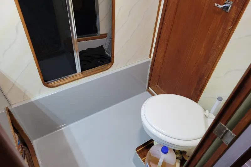 Slide: The Image of Bathroom interior of 1989 Bayliner 3888 Motoryacht with toilet and wooden accents. - 40