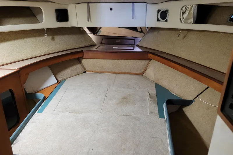 Slide: The Image of Interior cabin of 1989 Bayliner 3888 Motoryacht with carpeted flooring and wooden accents. - 44