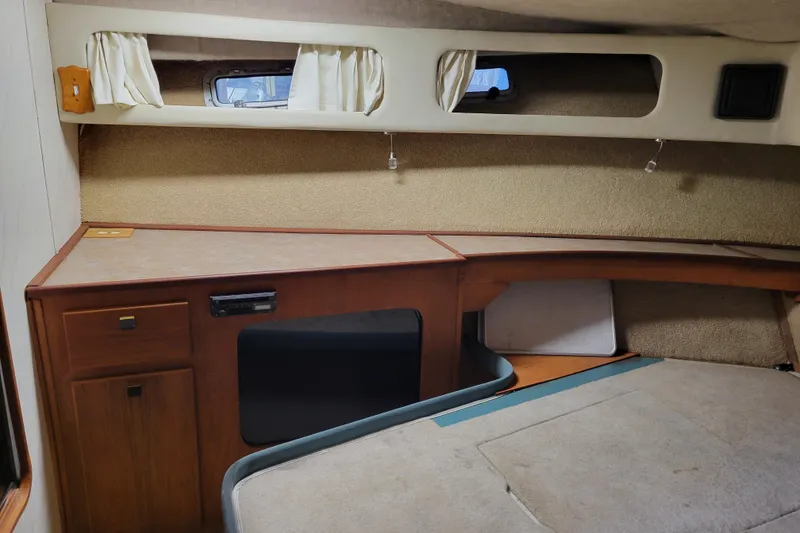 Slide: The Image of 1989 Bayliner 3888 Motoryacht cabin interior with wood cabinetry and small windows. - 45