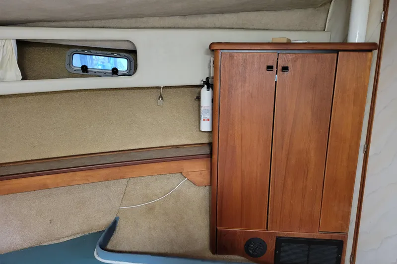 Slide: The Image of Interior of 1989 Bayliner 3888 Motoryacht with wooden cabinet and small window. - 46