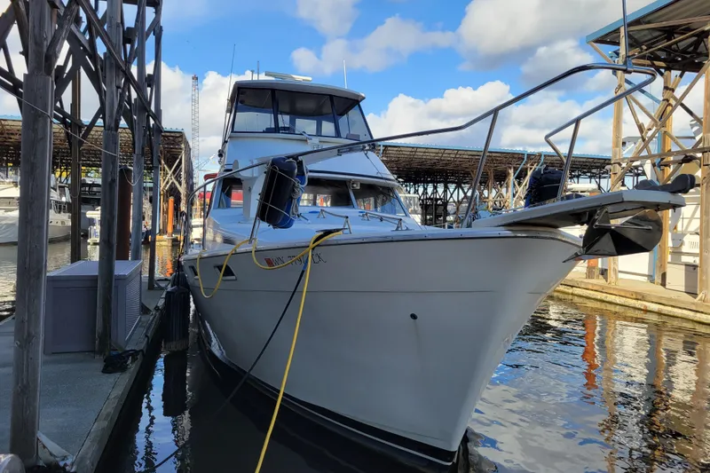 Slide: The Image of 1989 Bayliner 3888 Motoryacht docked at marina under blue sky. - 5
