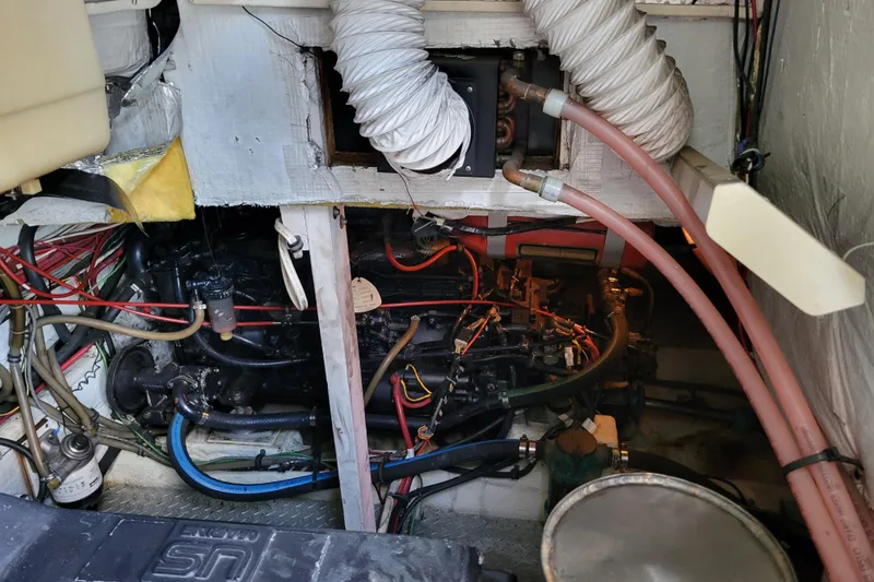 Slide: The Image of Engine room of 1989 Bayliner 3888 Motoryacht with visible wiring and hoses. - 51