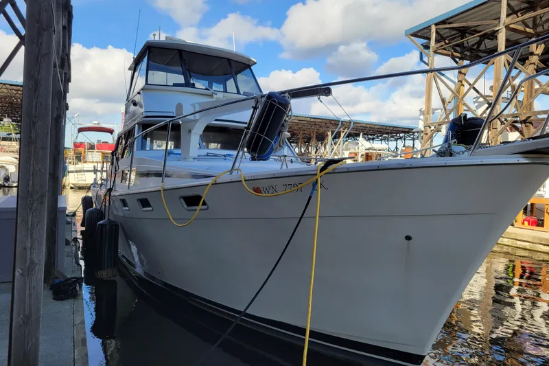 Slide: The Image of 1989 Bayliner 3888 Motoryacht docked at marina under blue sky. - 6
