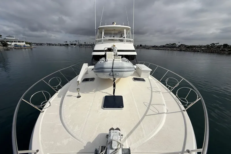 Slide: The Image of 1998 Riviera Convertible yacht on calm water under cloudy skies. - 11