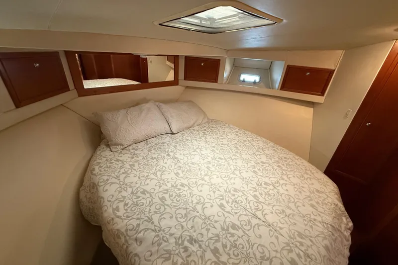 Slide: The Image of 1998 Riviera Convertible cabin with cozy bed and elegant wood cabinetry. - 28