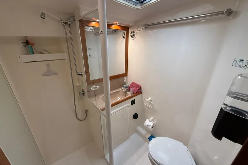 Slide: The Image of 1998 Riviera Convertible yacht bathroom with shower, sink, and toilet. - 29