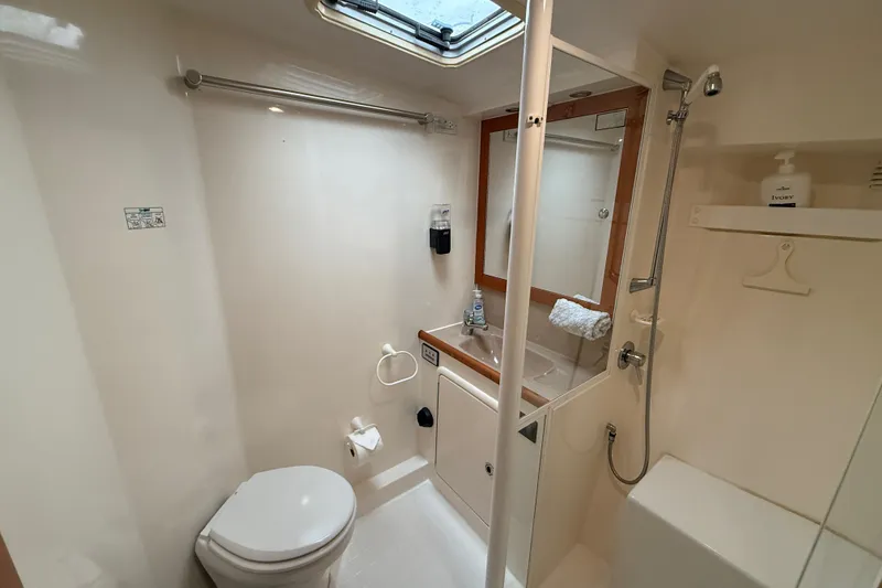 Slide: The Image of 1998 Riviera Convertible yacht bathroom with shower, toilet, and sink. - 30
