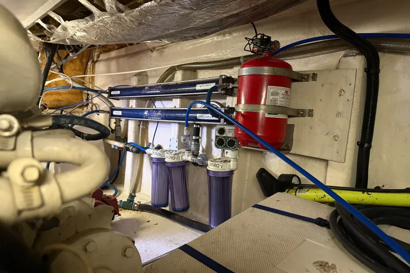 Slide: The Image of Engine room of a 1998 Riviera Convertible with filtration system and fire extinguisher. - 35