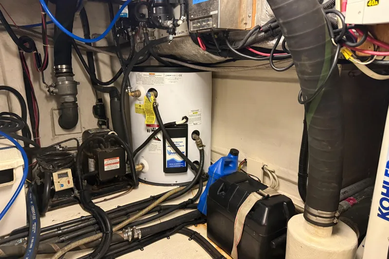 Slide: The Image of Engine room of a 1998 Riviera Convertible with various mechanical components and wiring. - 37