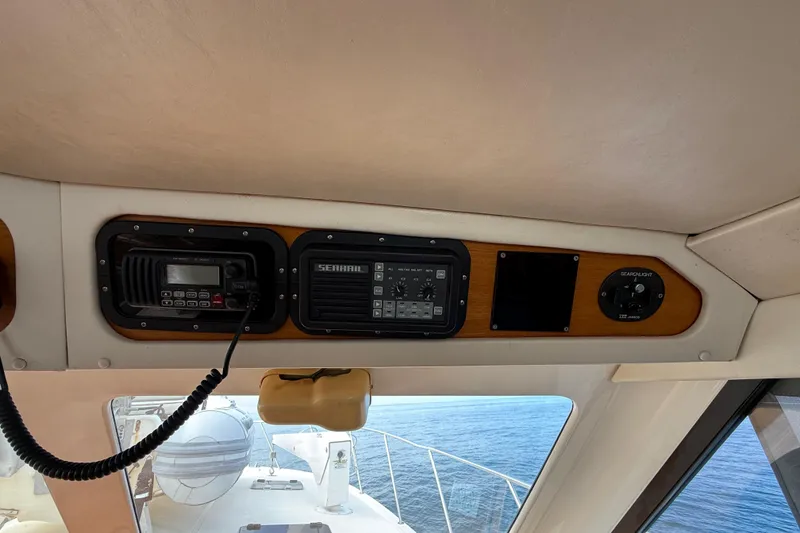 Slide: The Image of 1998 Riviera Convertible boat dashboard with radio and control panel, overlooking the ocean. - 41