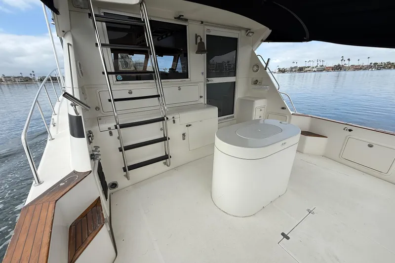 Slide: The Image of 1998 Riviera Convertible boat deck with seating, ladder, and ocean view. - 8