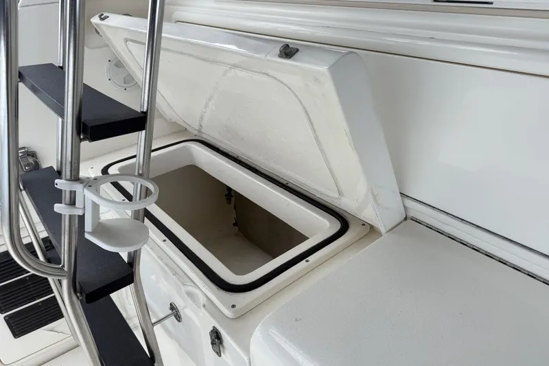 Slide: The Image of Open storage compartment on 1998 Riviera Convertible boat with adjacent ladder. - 10