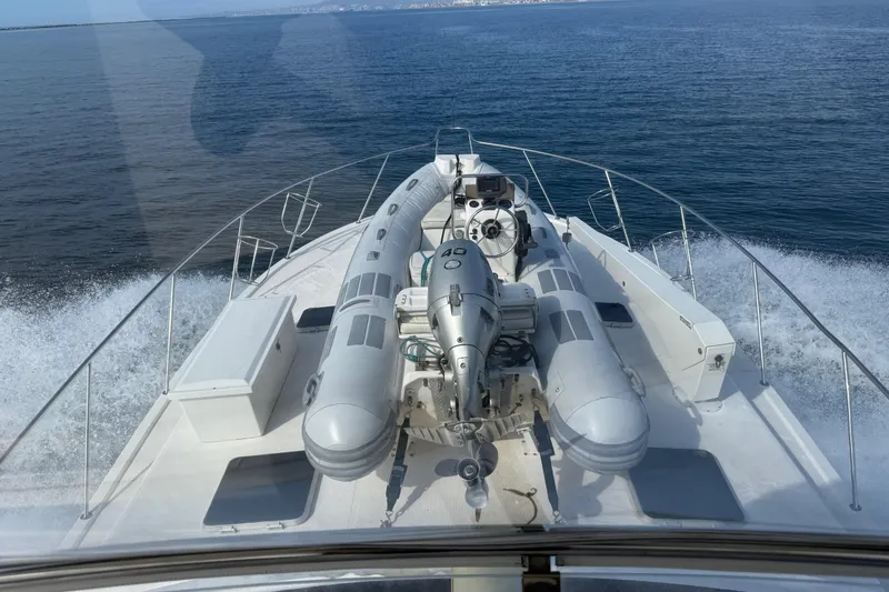 Slide: The Image of 1998 Riviera Convertible yacht cruising with inflatable boat on deck. - 12