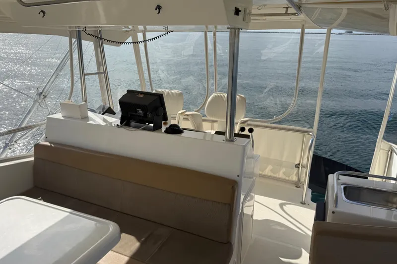 Slide: The Image of 1998 Riviera Convertible yacht interior with helm, seating, and ocean view. - 16