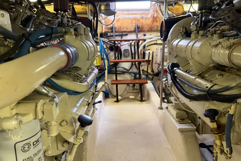 Slide: The Image of Engine room of a 1998 Riviera Convertible boat with visible machinery and wiring. - 34